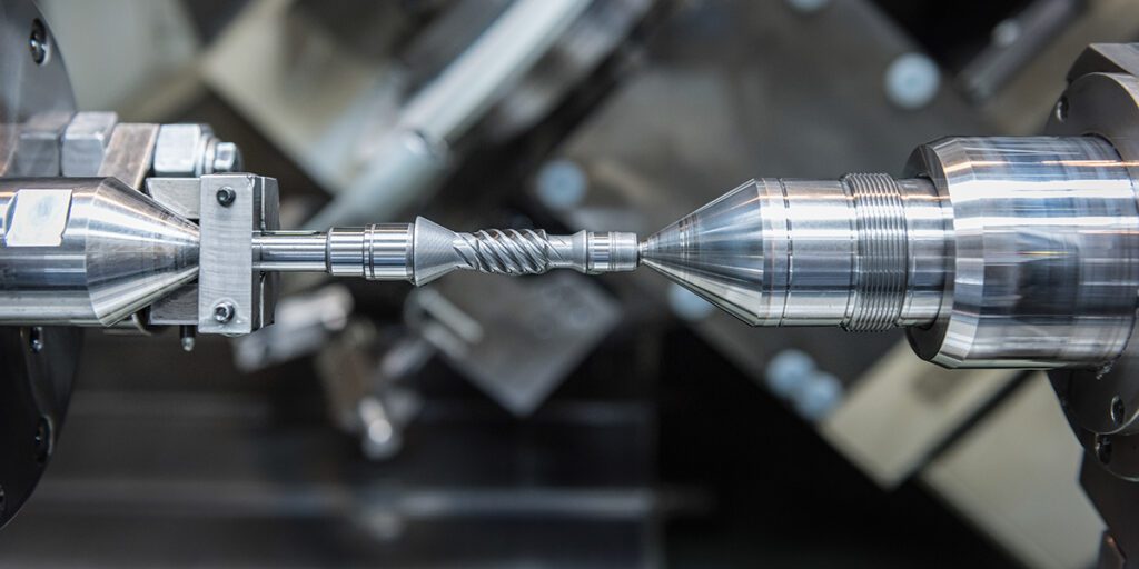 Small steel drive gear in engineering factory close up