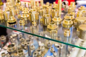 Brass fitting pieces on glass shelves