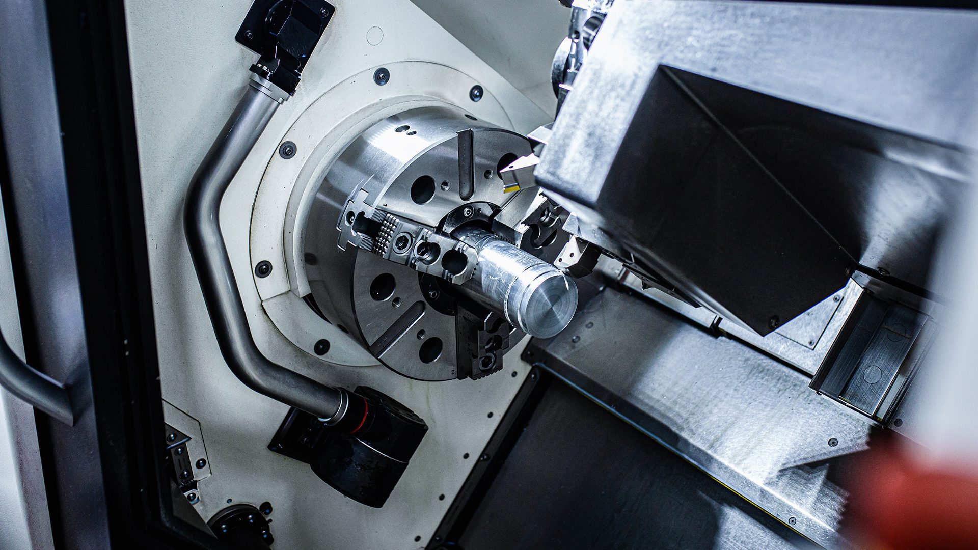 Close up of a CNC machine spindle with tooling attached metal workpiece clamped for precision machining